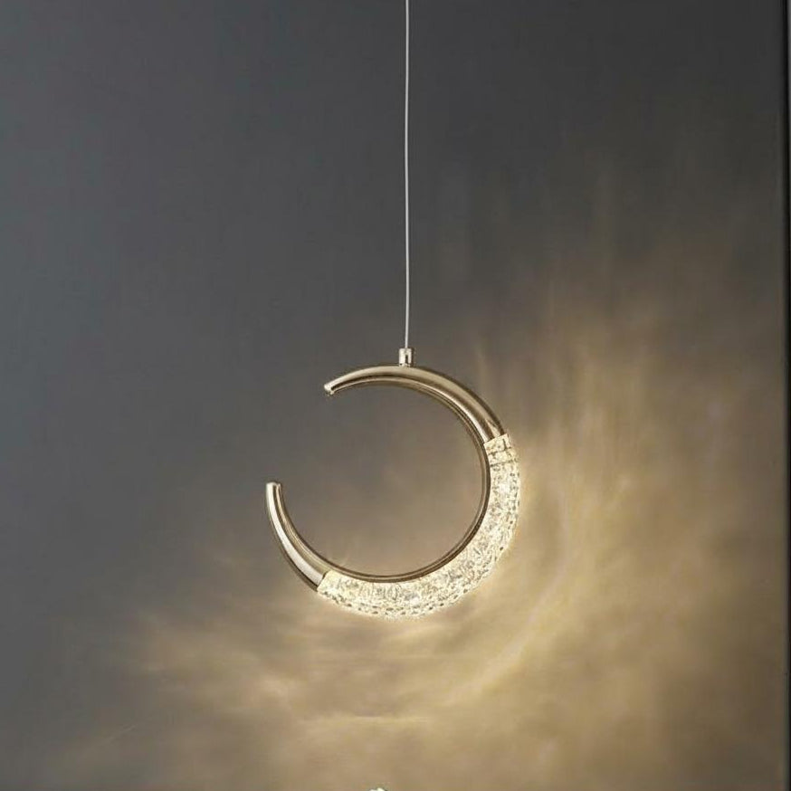 Decorative hanging light fixture with crystal details on a dark background