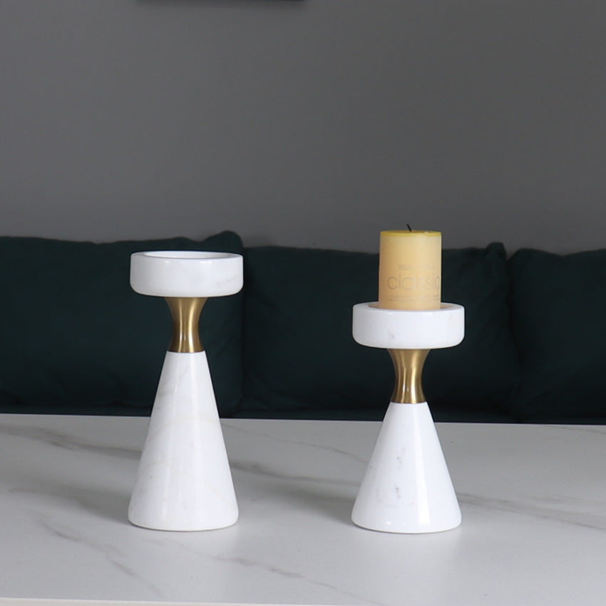 Two different sized white marble candle holders styled in a modern living room setting