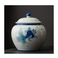 Single white porcelain jar featuring a blue ink-wash style goldfish painting with an elegant blue rim
