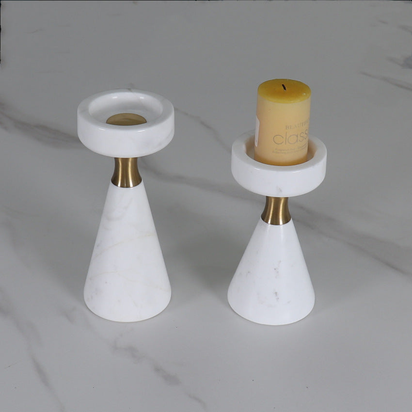 Top down view of marble candle holders showing the deep brass receptacle for candles