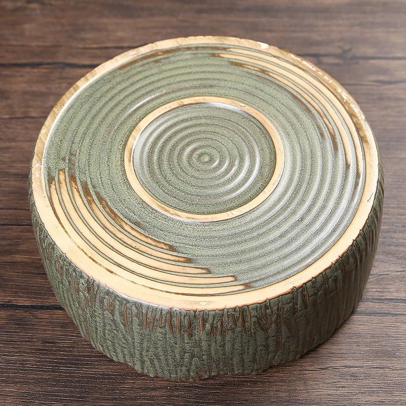 Handcrafted pottery base detail showing unglazed ring and circular texture