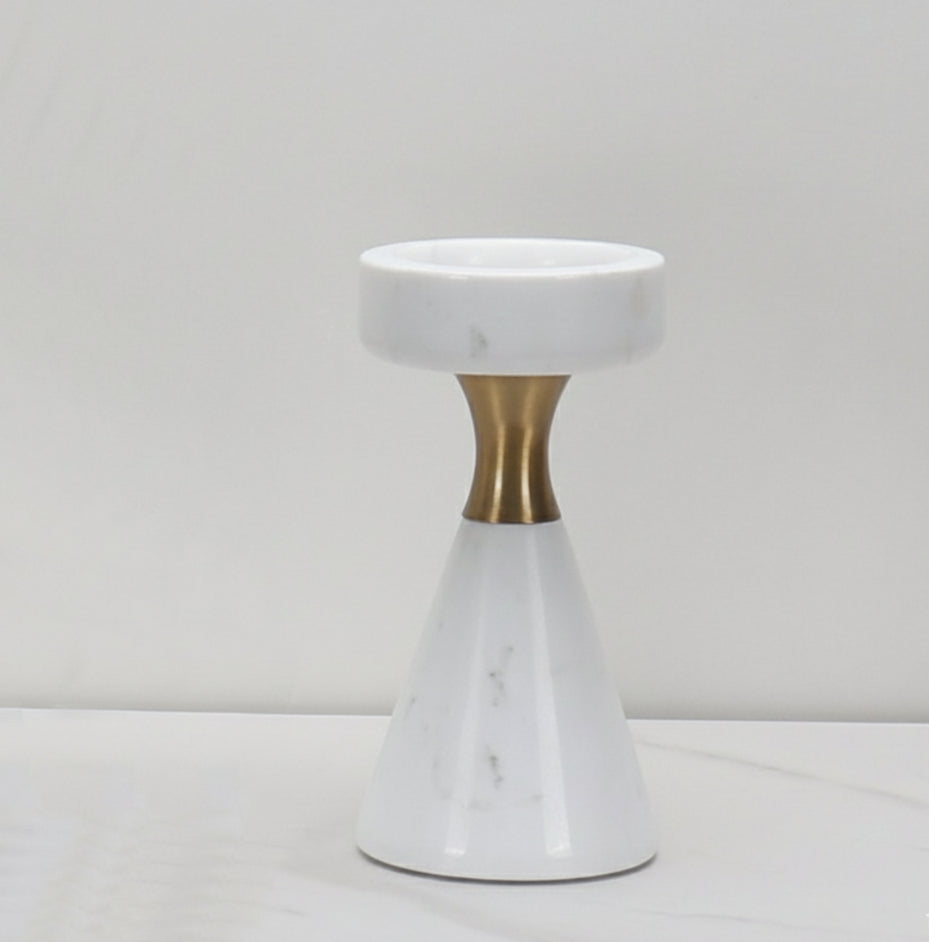 Front view of the small sculptural white marble candle holder with brass neck