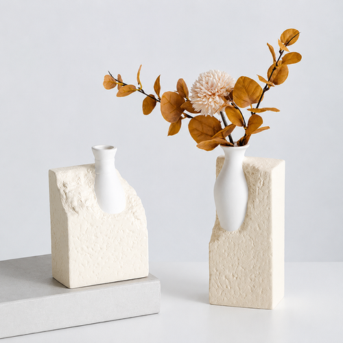Beige abstract ceramic vases styled with warm brown foliage