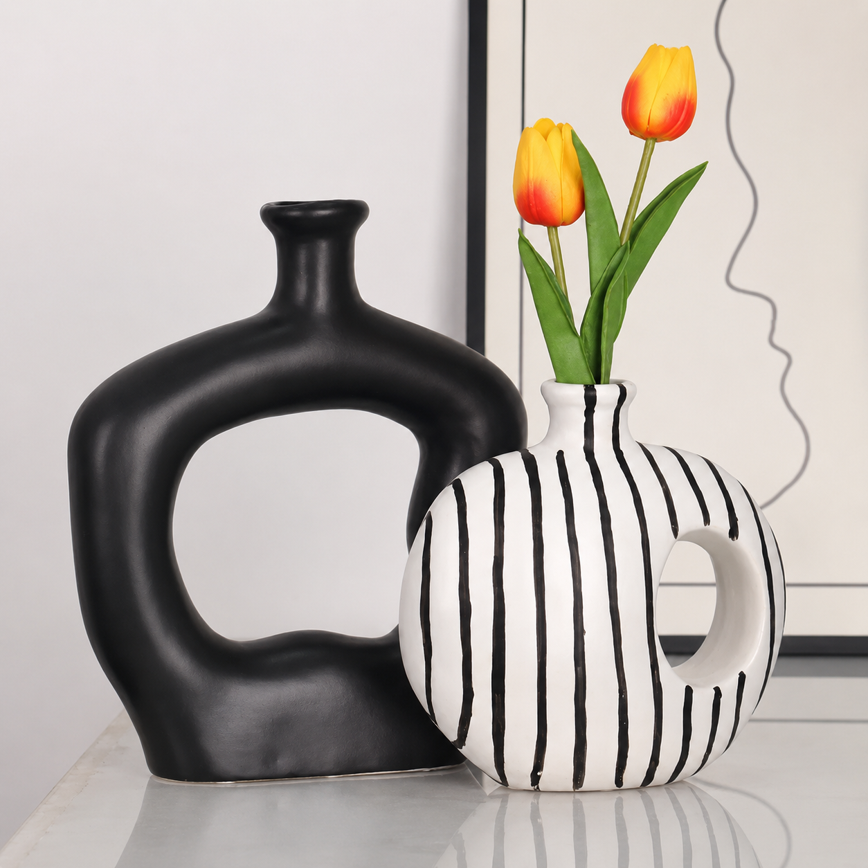 Matte black and striped ceramic vases displayed in modern interior