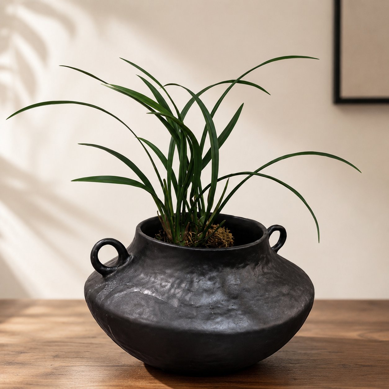 Close up of black ceramic vase handle and textured dark surface