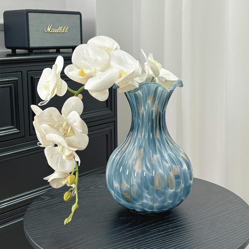 Blue ruffled art glass vase with white orchid flowers for elegant home decor