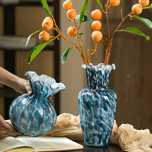 Blue ruffled art glass vases with decorative gold accents and floral branches