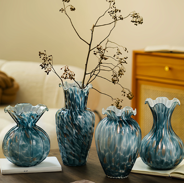 Blue art glass vase set with ruffled rims displayed with dried branches