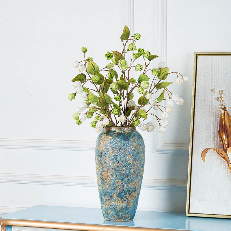 Tall blue gold textured ceramic flower vase styled with purple and white blossoms
