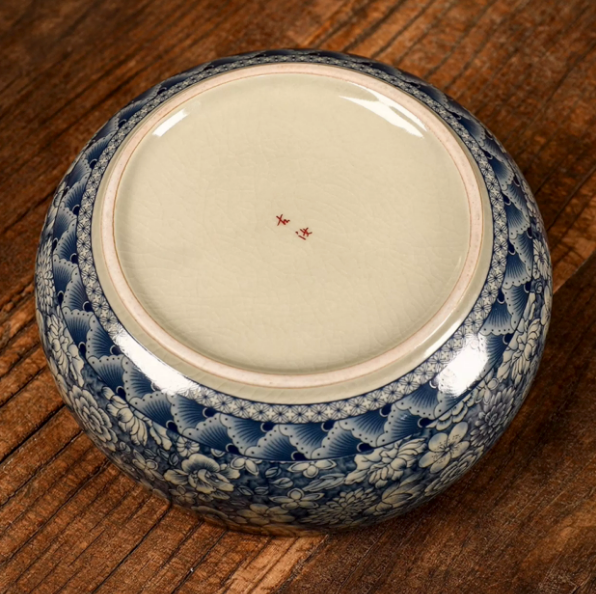 Bottom view of blue and white floral ceramic serving bowl with glazed base