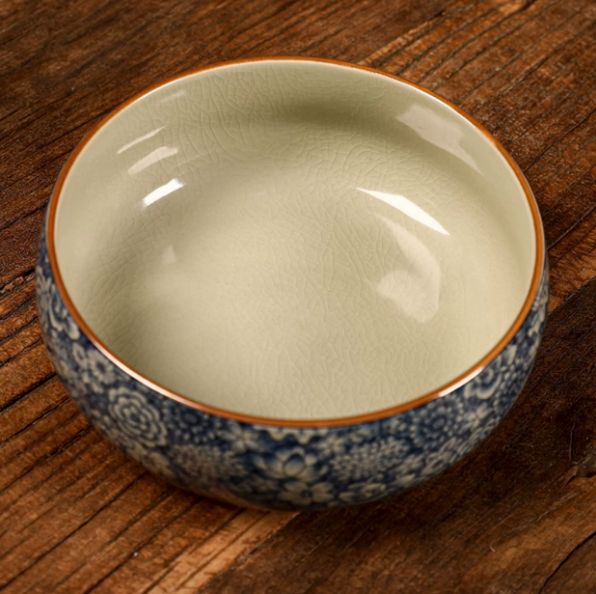 Interior view of blue and white floral ceramic serving bowl with pale glazed finish