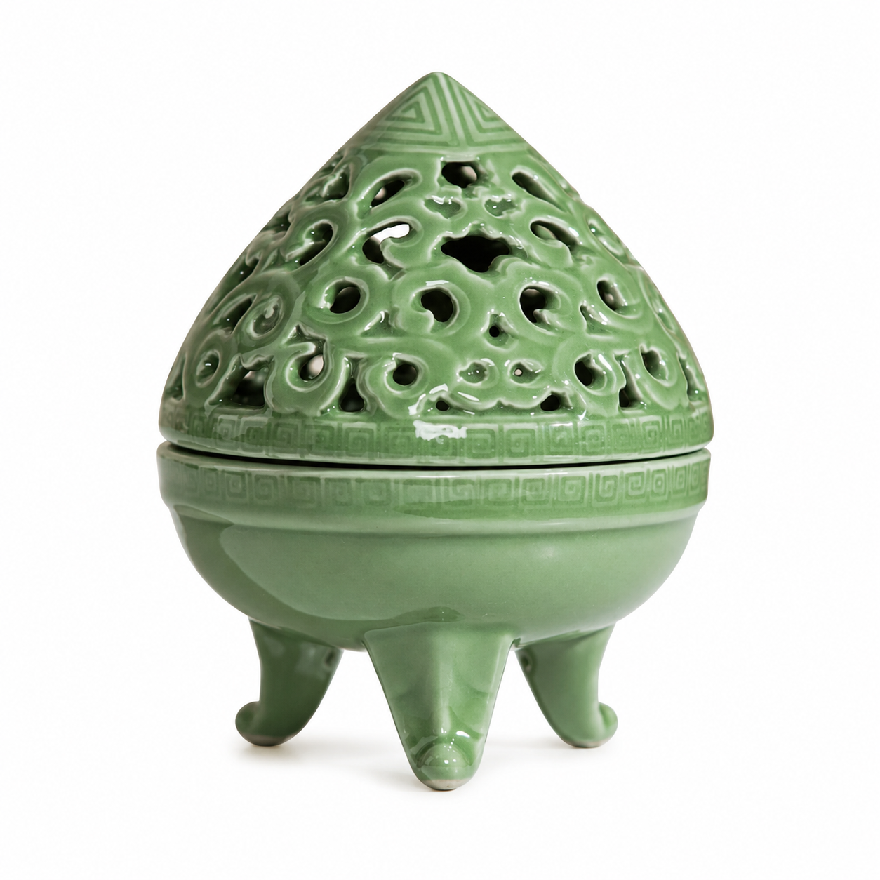 Teardrop-shaped celadon green ceramic incense burner with pierced lid and three feet on white background