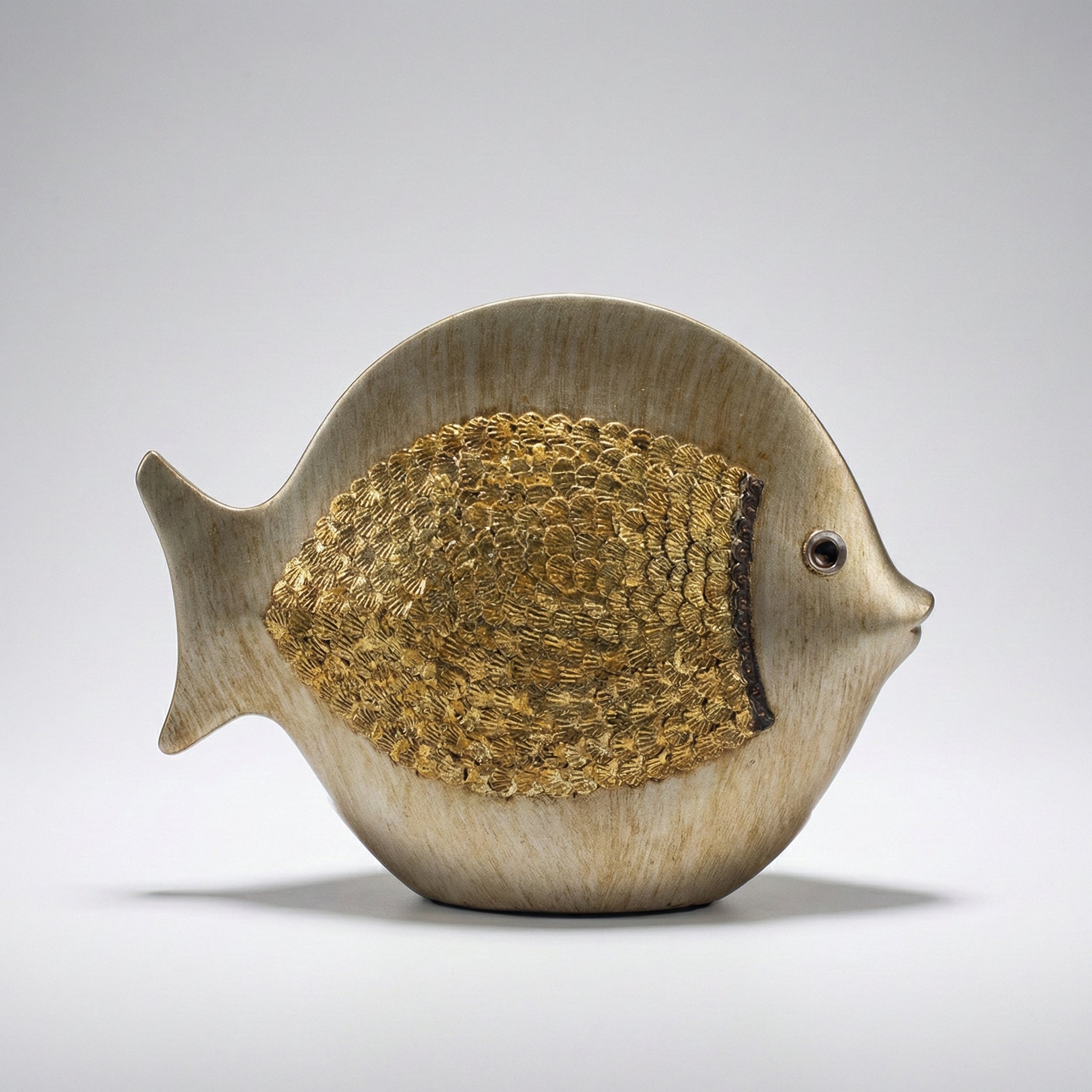 Round ceramic fish sculpture with textured scale detailing in beige finish