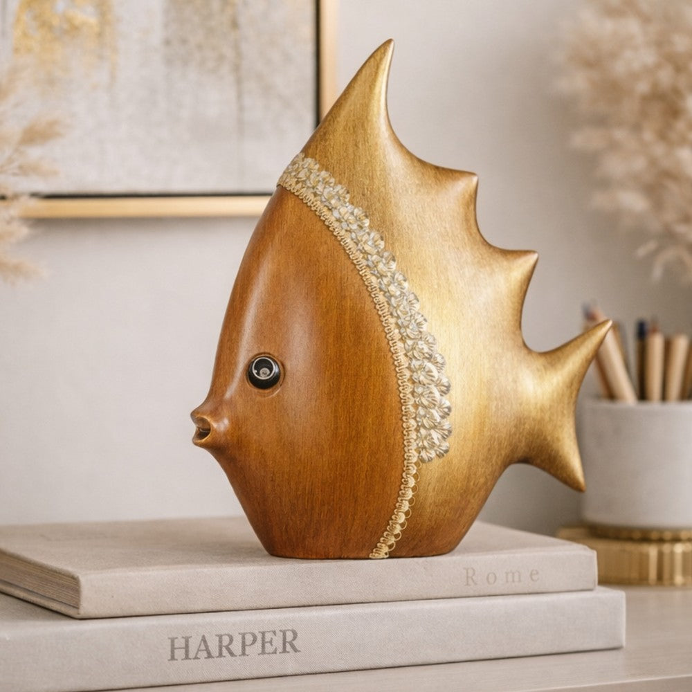 Brown crested fish figurine styled on books in a warm neutral setting