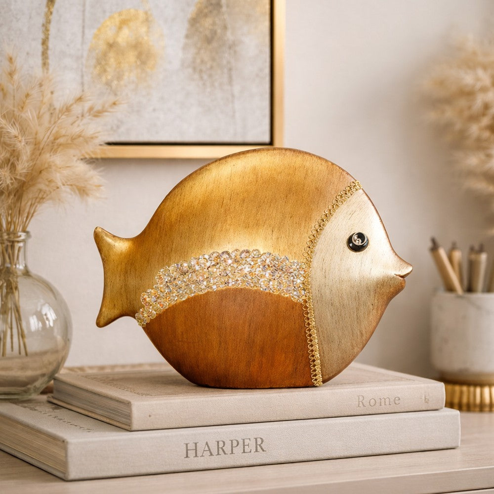 Round ceramic fish decor piece on books with pampas grass and framed wall art