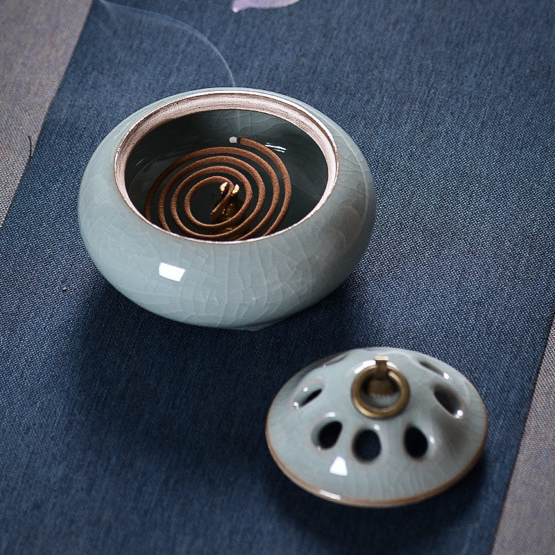 Blue Gray ceramic incense burner open with incense coil and removable ventilated lid