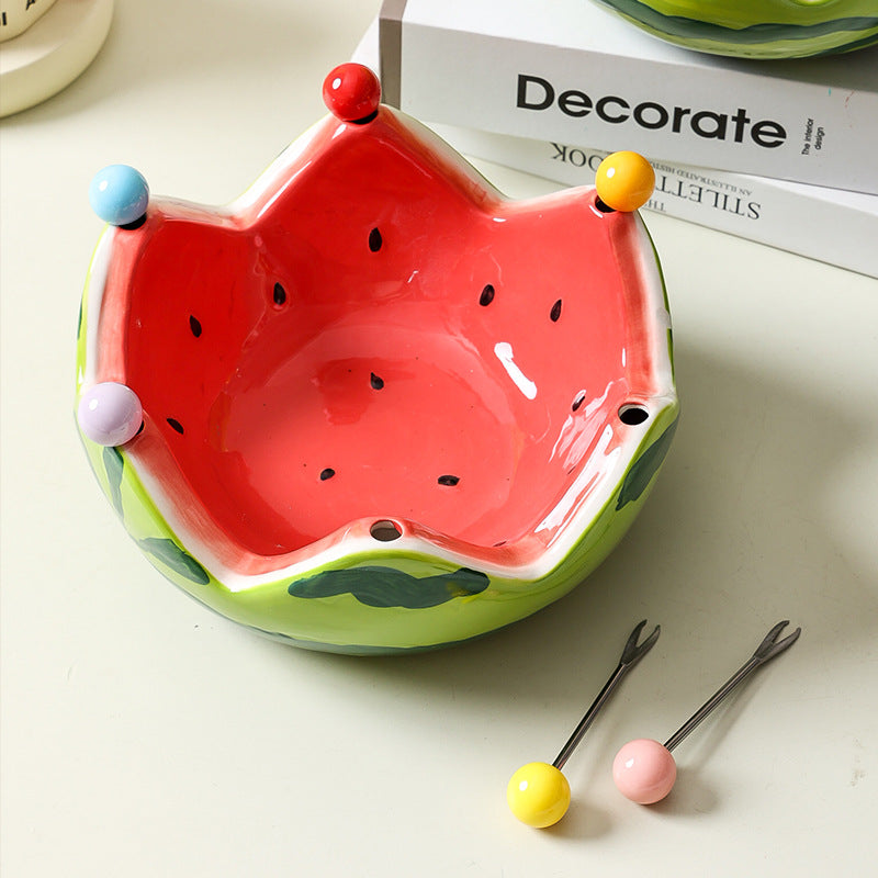 Watermelon inspired ceramic crown fruit bowl in red with fruit pieces on a tabletop