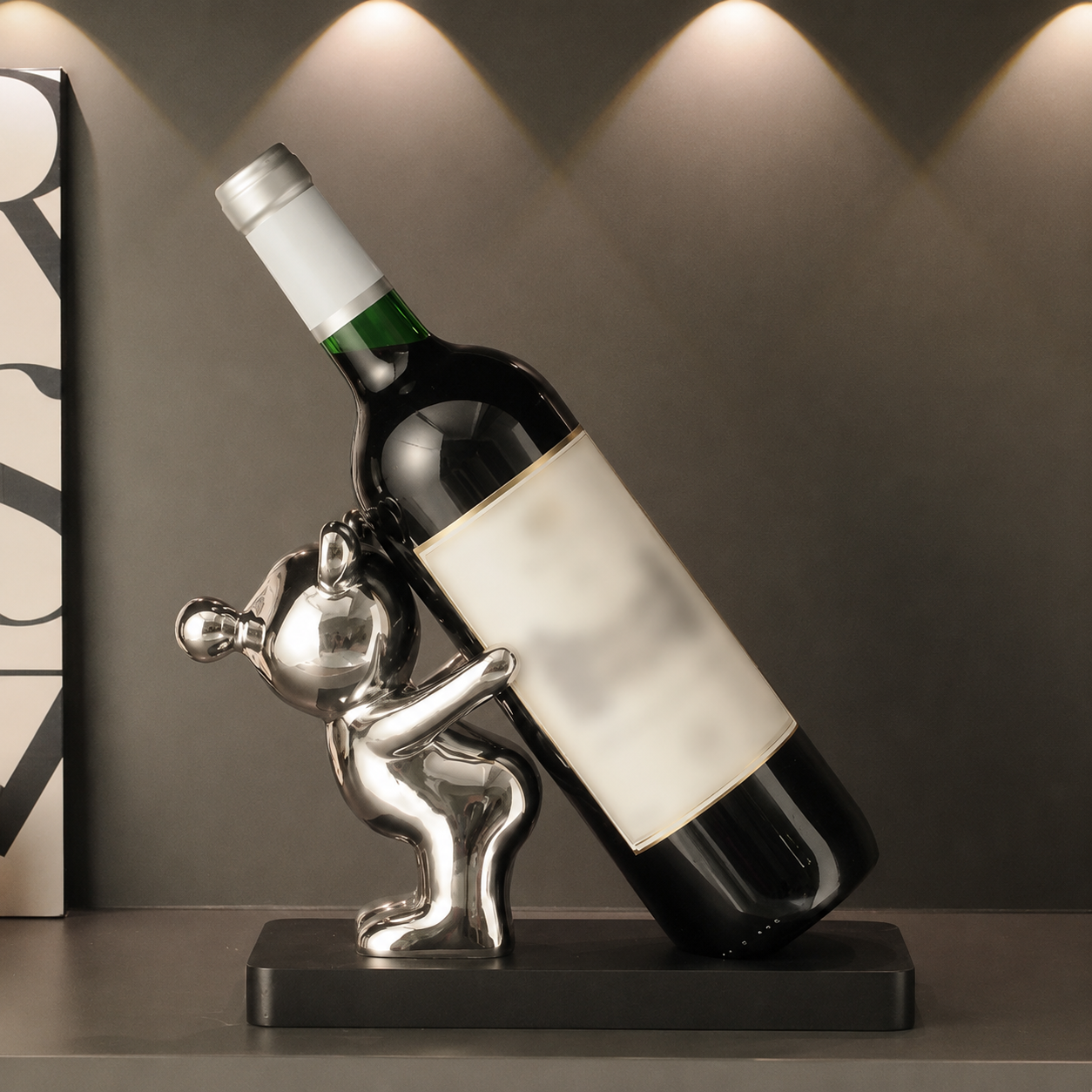 Silver bear ceramic wine bottle holder with wine bottle on black wood base
