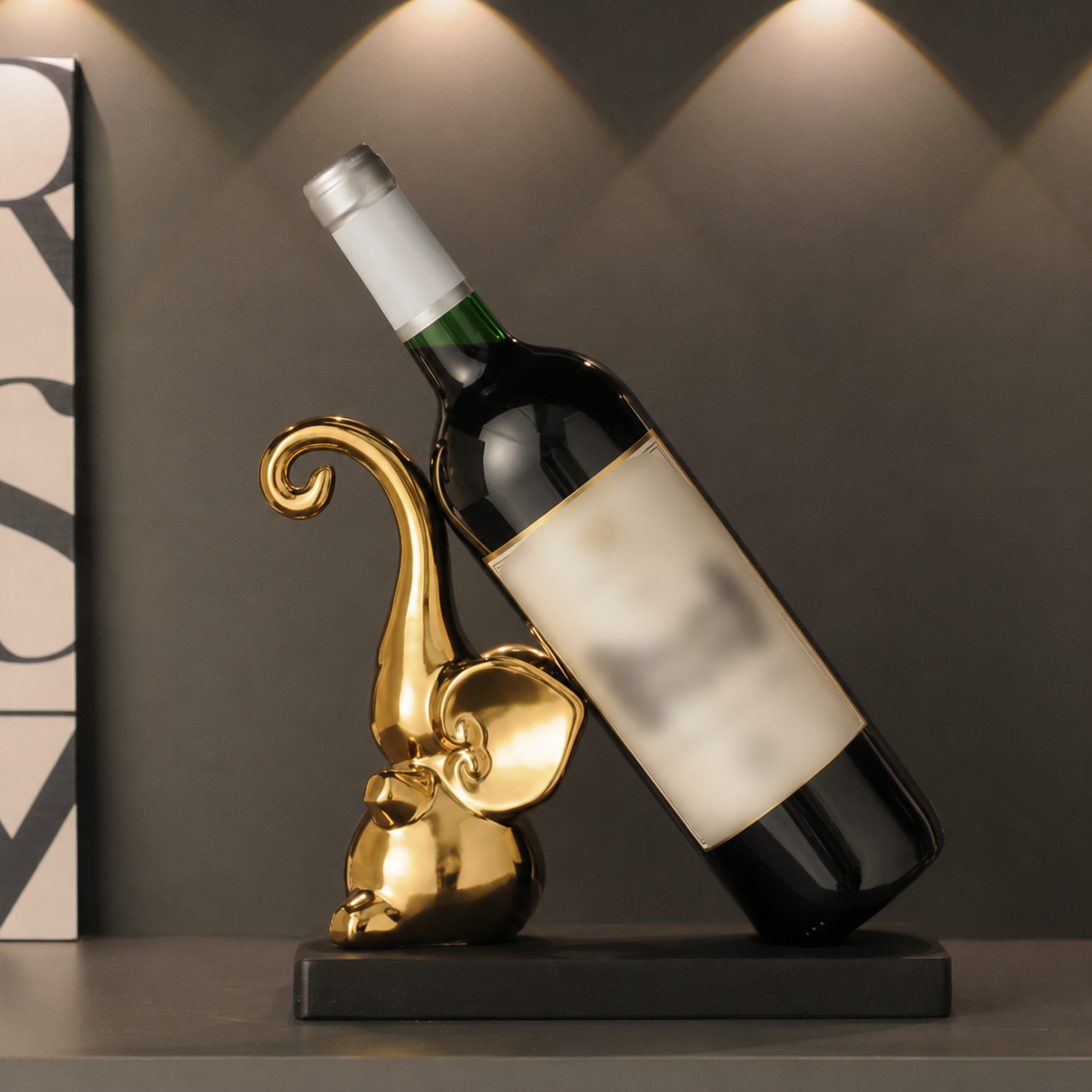 Gold elephant ceramic wine bottle holder with wine bottle on black wood base