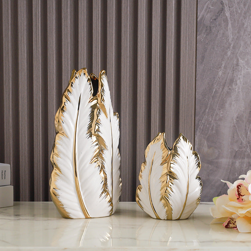 Gold electroplated ceramic plantain leaf vases in large and medium on a modern tabletop