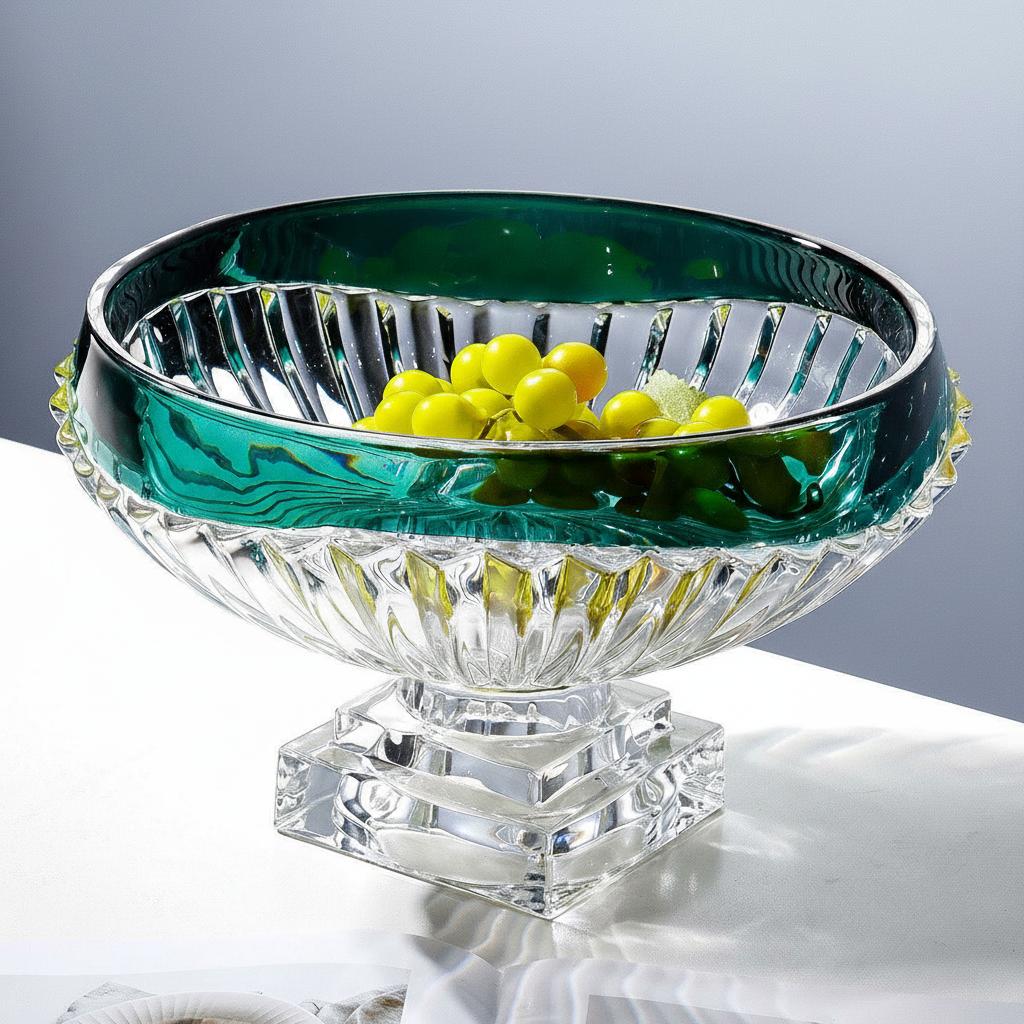 Emerald green fluted glass pedestal centerpiece bowl filled with yellow fruit