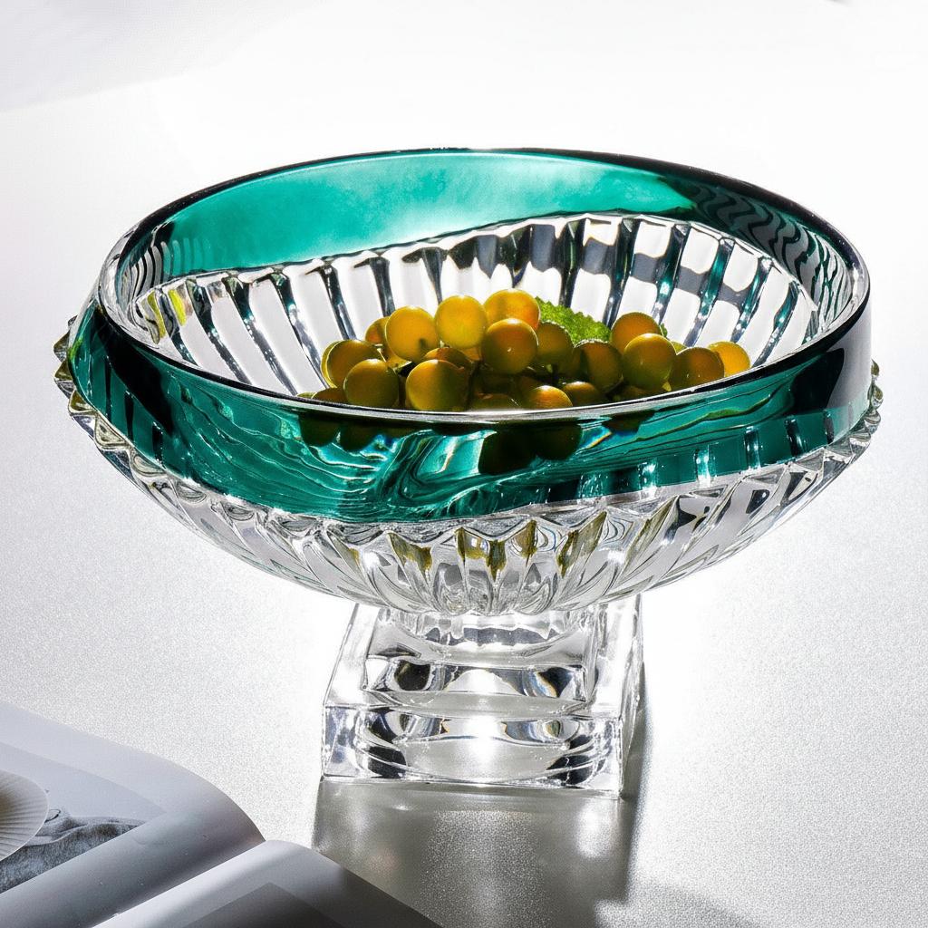 Emerald green glass pedestal centerpiece bowl styled with decorative fruit
