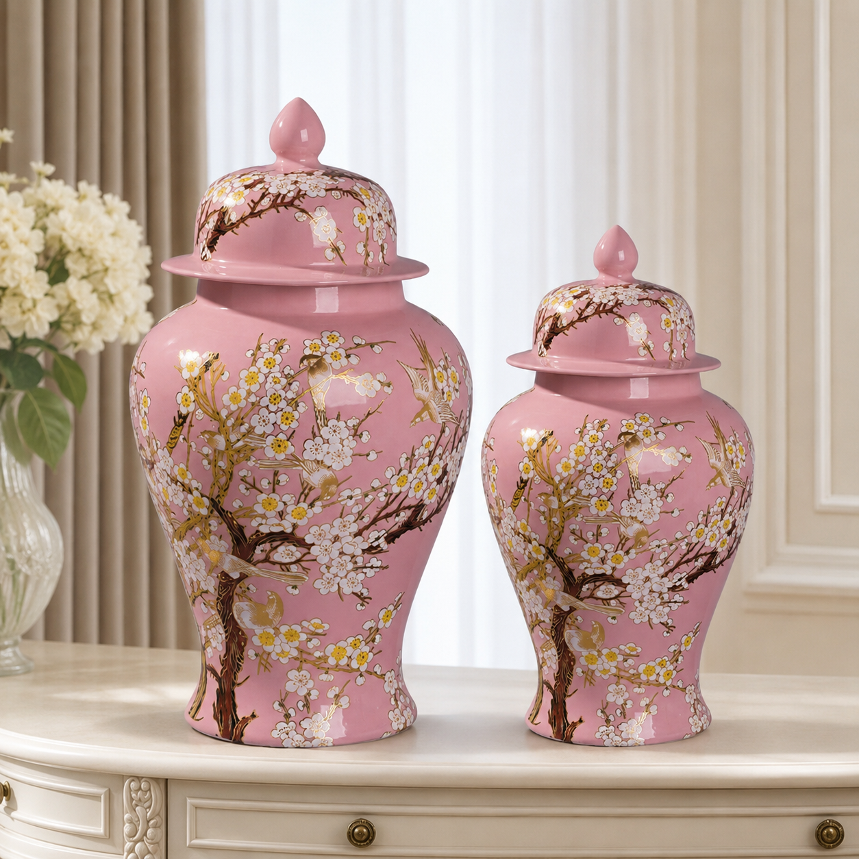 Pink floral bird ceramic ginger jar vase pair in two sizes displayed together on a tabletop