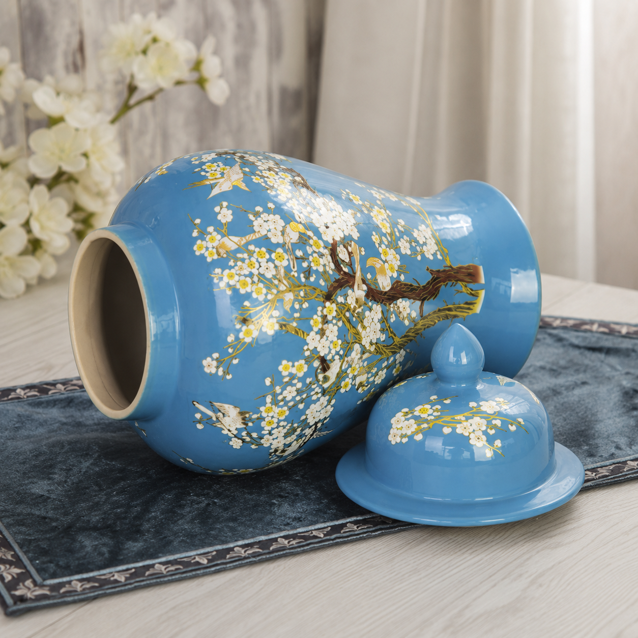 Blue floral bird ceramic ginger jar vase lying on its side with matching lid beside it