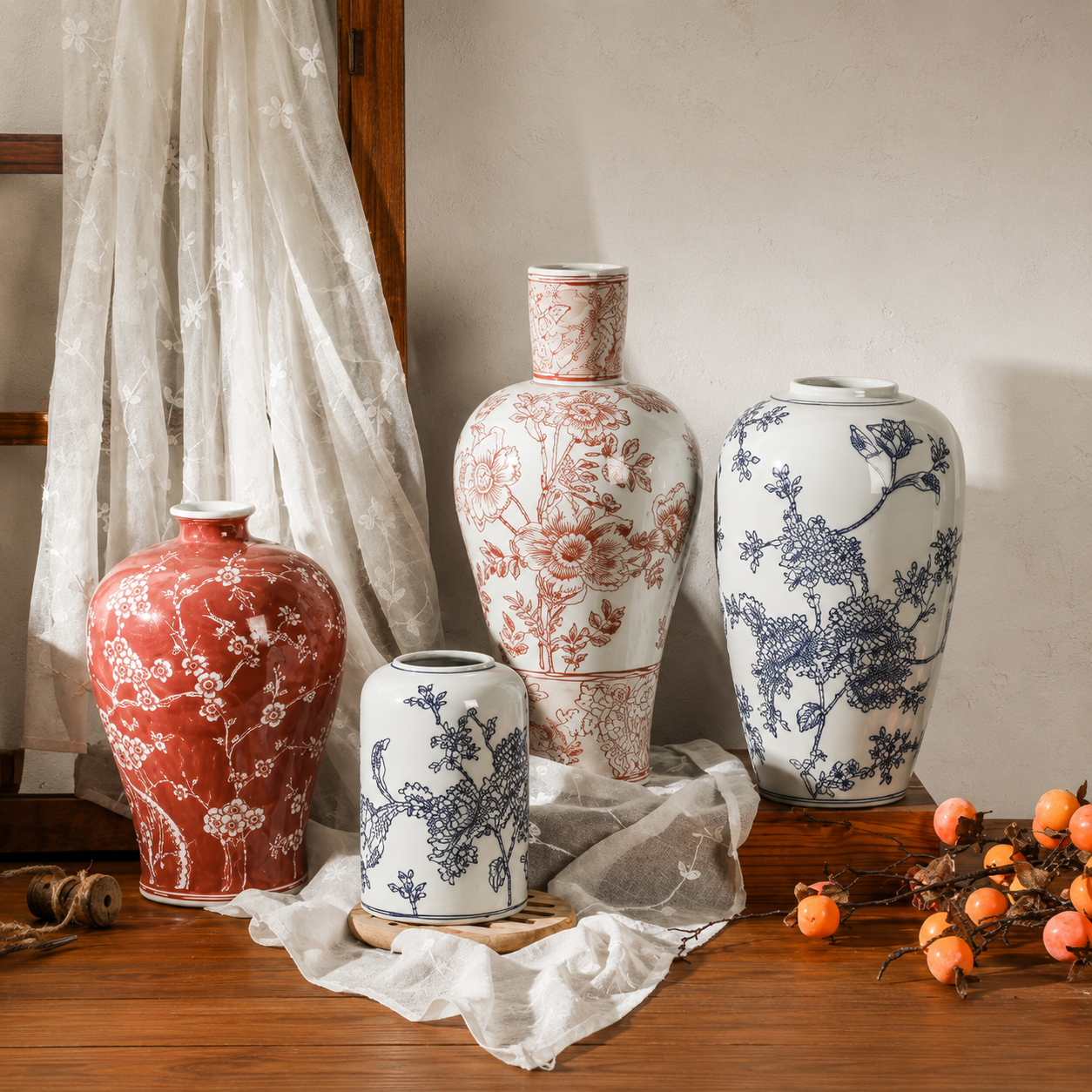 Floral ceramic decorative vases in red, blue, and brown styles arranged on a wooden console