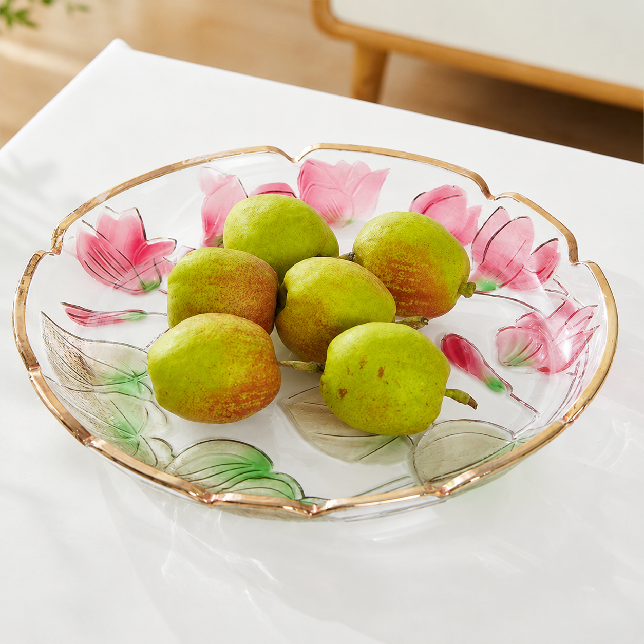 Floral embossed glass centerpiece plate filled with fresh green pears