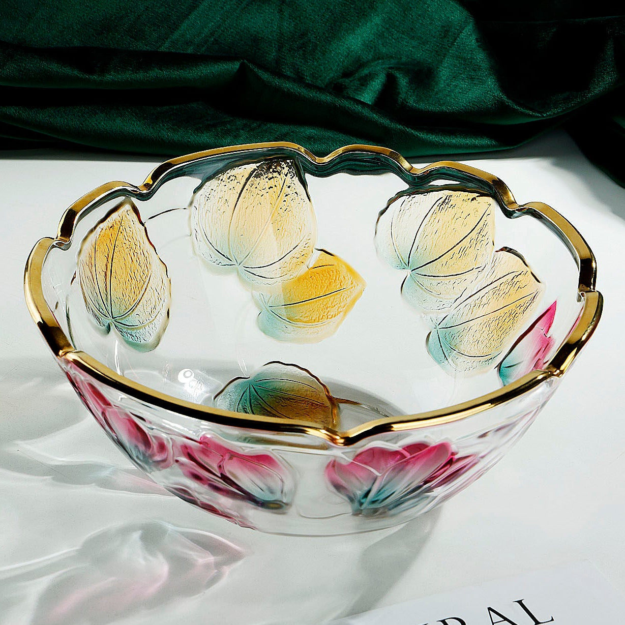 Floral embossed glass centerpiece bowl shown from above with colorful botanical motifs