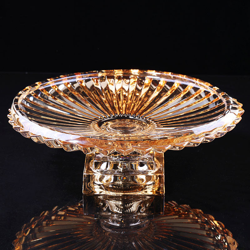 Amber fluted glass pedestal centerpiece bowl displayed against a dark background