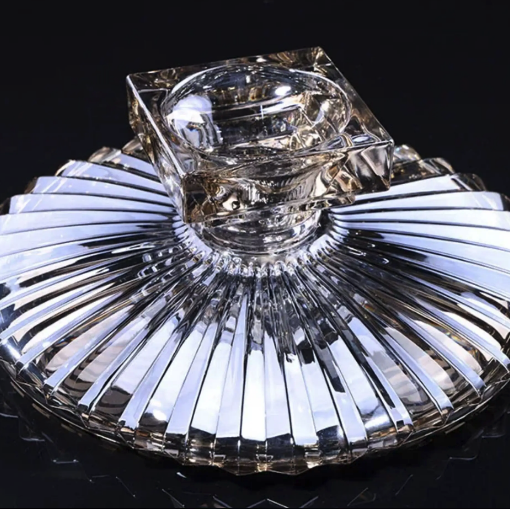 Close up underside view of clear fluted glass centerpiece bowl and geometric pedestal base