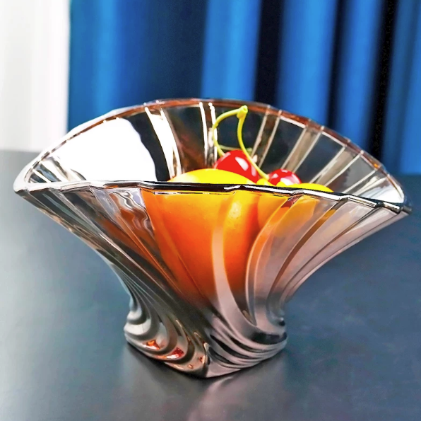 Gray fluted glass centerpiece bowl styled with colorful fruit