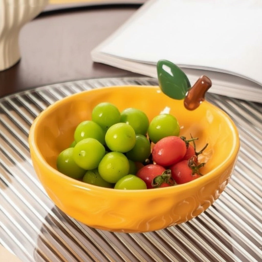 Fruit-inspired ceramic serving bowl with grapes and cherry tomatoes on a dining table