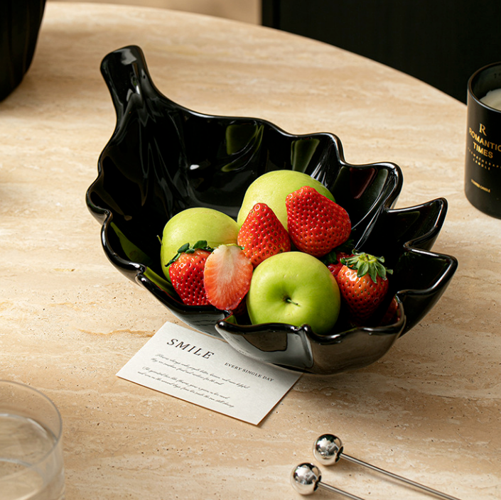 Black glossy ceramic leaf bowl with fruit for decorative home display