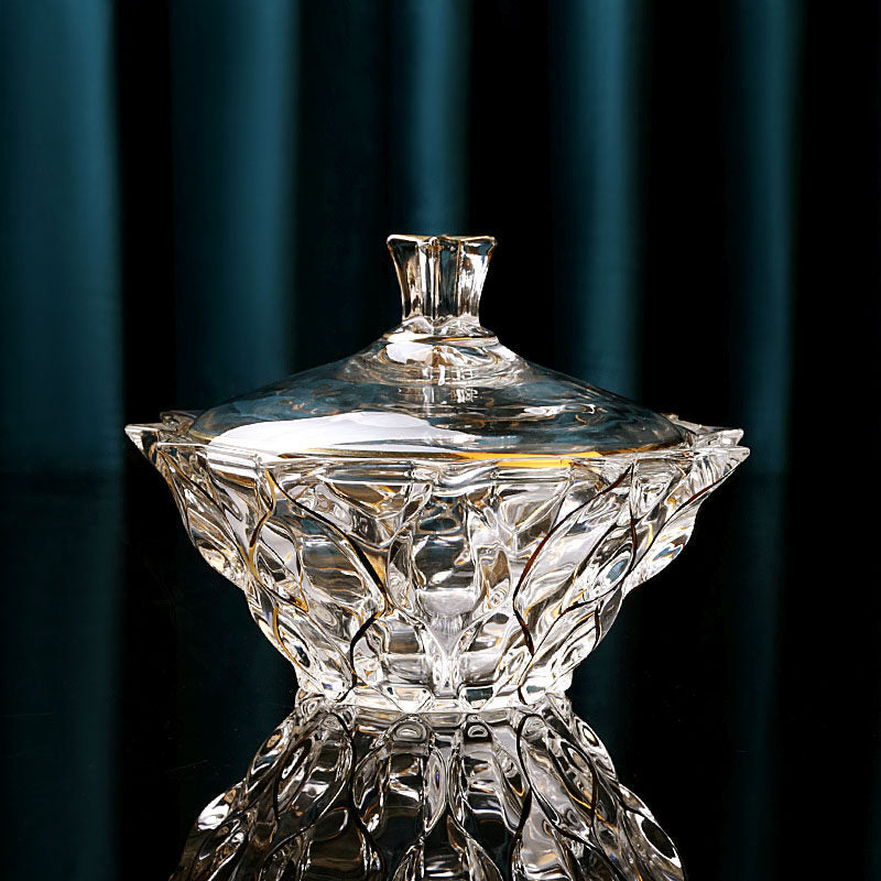 Closed gold accented faceted glass lidded bowl with star shaped finial