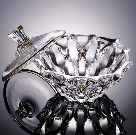 Angled view of clear faceted glass bowl showing sculptural petal detailing
