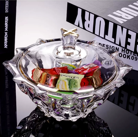 Faceted glass lidded bowl opened and filled with colorful wrapped sweets