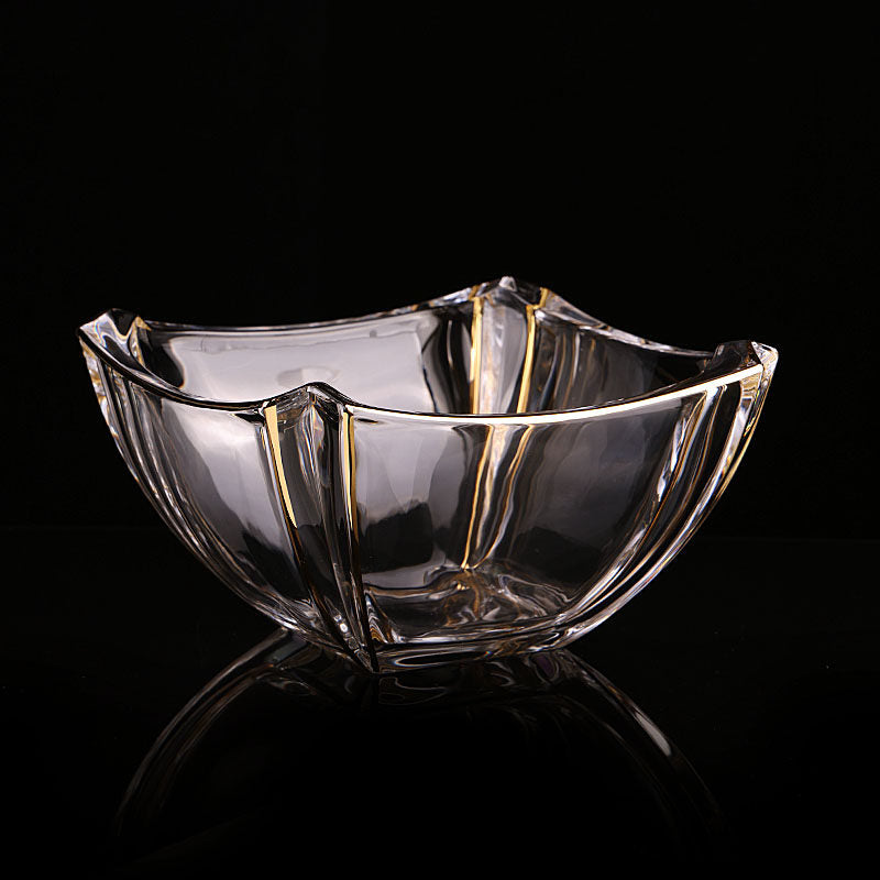 Angled view of clear wavy glass bowl with gold rim