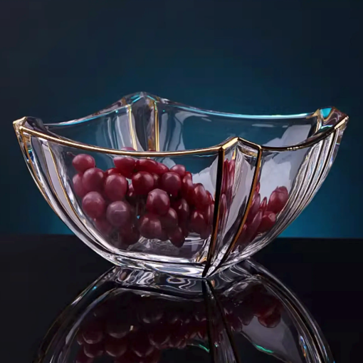 Gold rimmed wavy glass bowl filled with red grapes