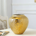 Short round gold tone ceramic vase with electroplated finish