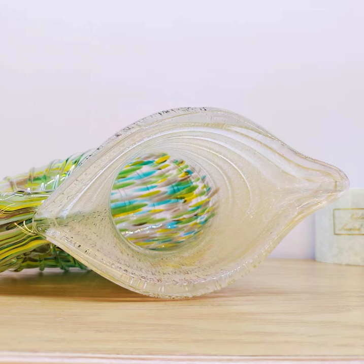 Top view of green and amber nautilus shell art glass vase with wide opening