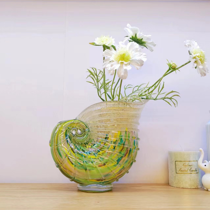Nautilus shell art glass vase with white flowers for coastal home decor