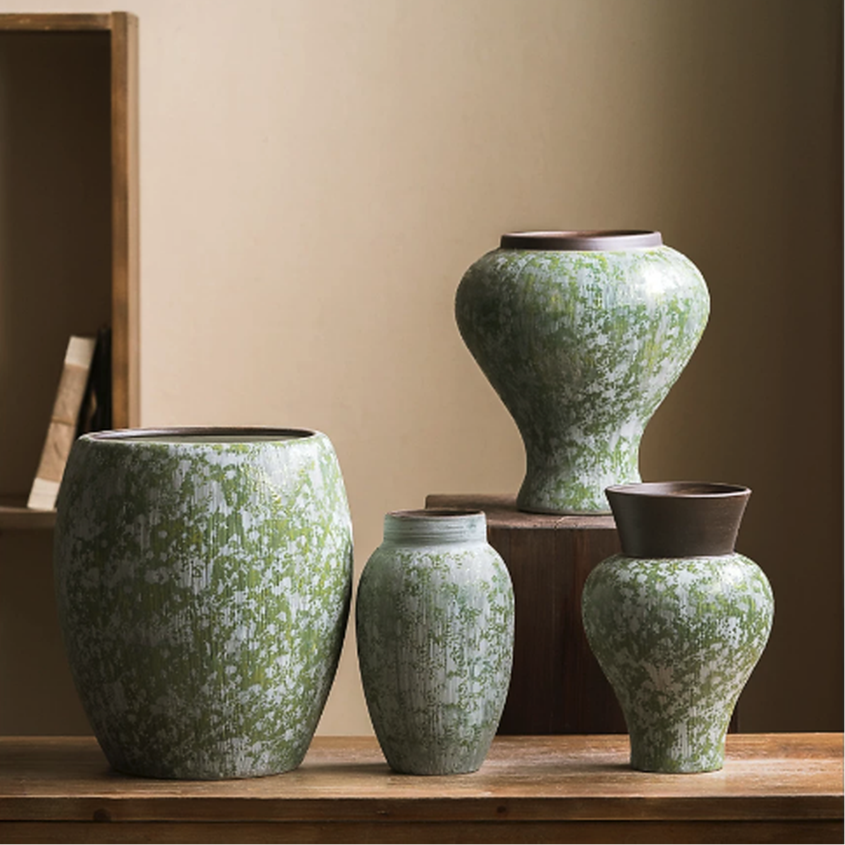 Collection of green speckled ceramic vases in rustic farmhouse home decor setting