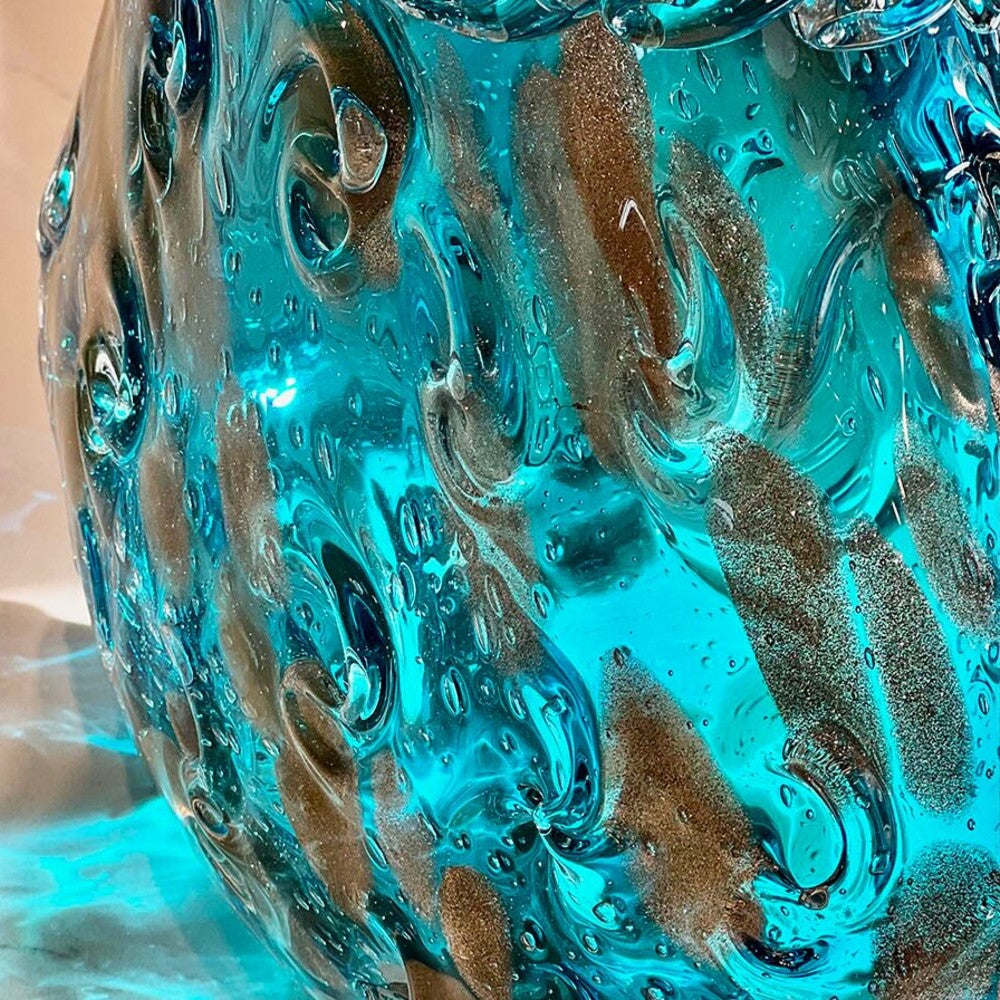 Close up of blue art glass vase with shimmering gold flecks