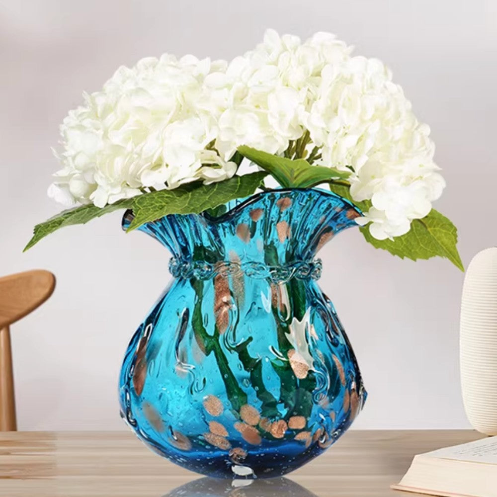 Blue glass vase with white hydrangeas for elegant home decor