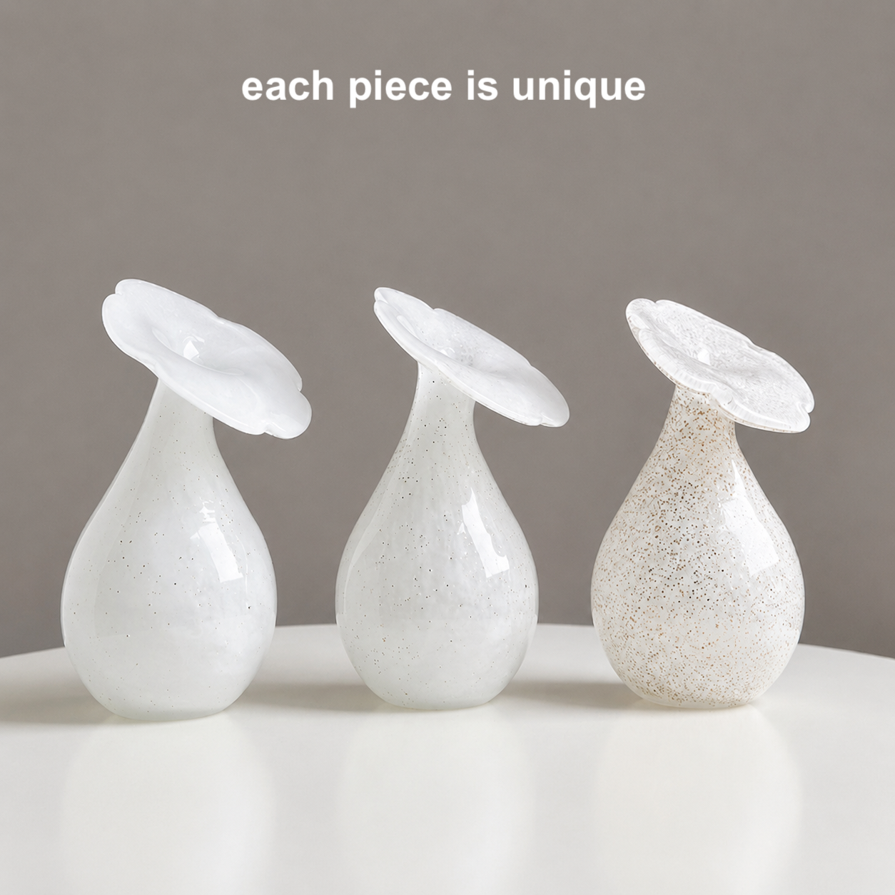 Three hand-blown glass bud vases in white and gold speckled finishes