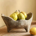 Hand carved wood footed centerpiece bowl styled with fresh pears on a rustic table