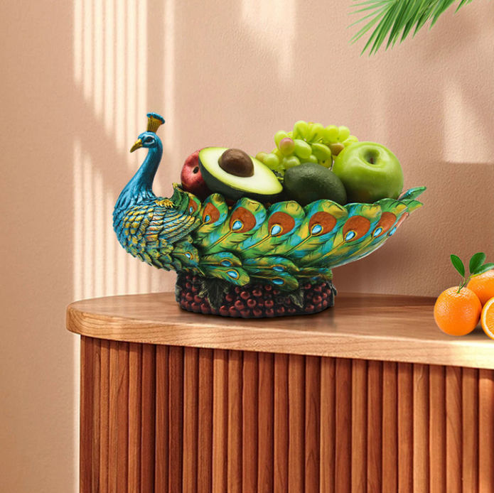 Hand-painted resin peacock fruit bowl centerpiece styled on a wooden pedestal with green apples